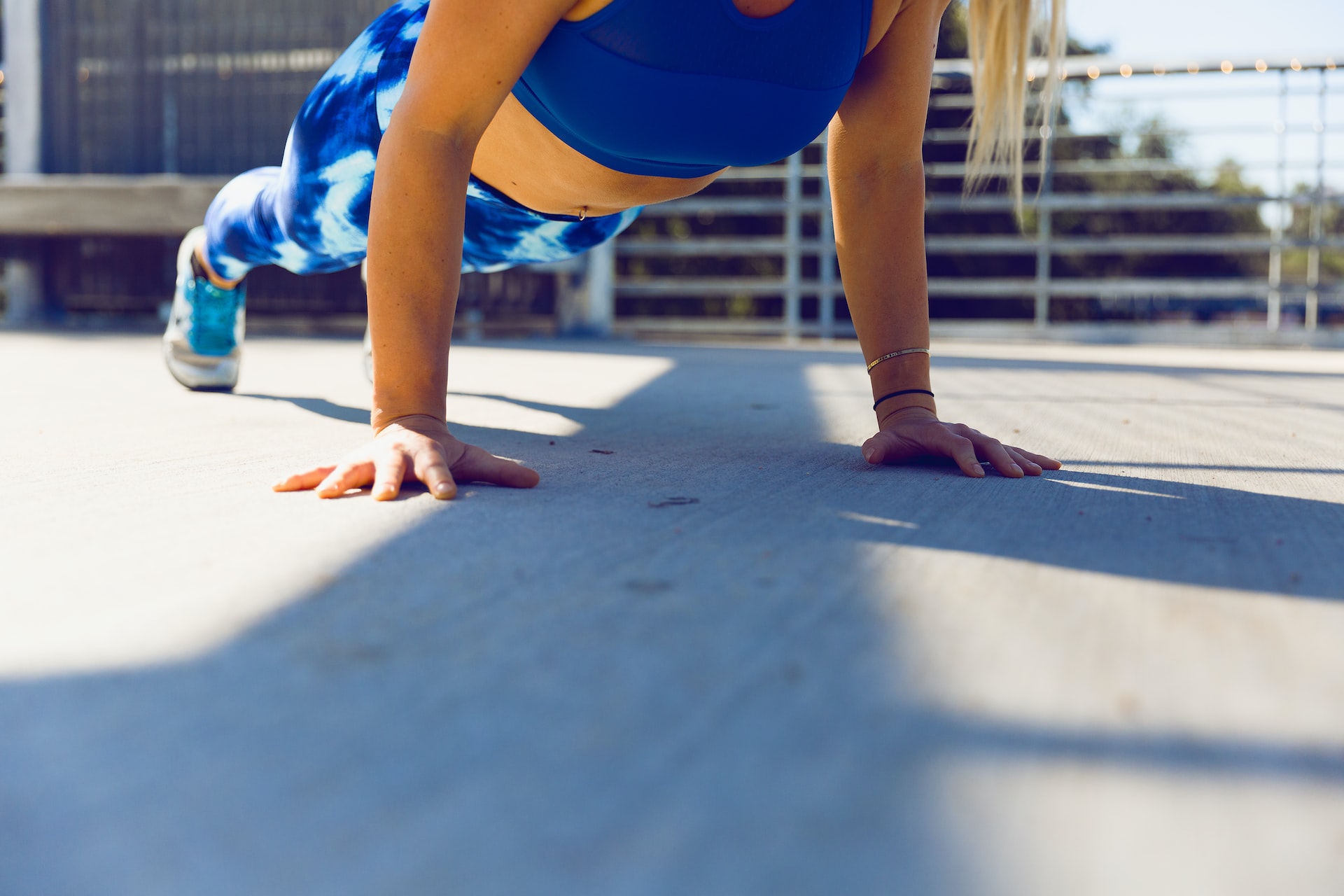 women doing a plank in blue workout clothing