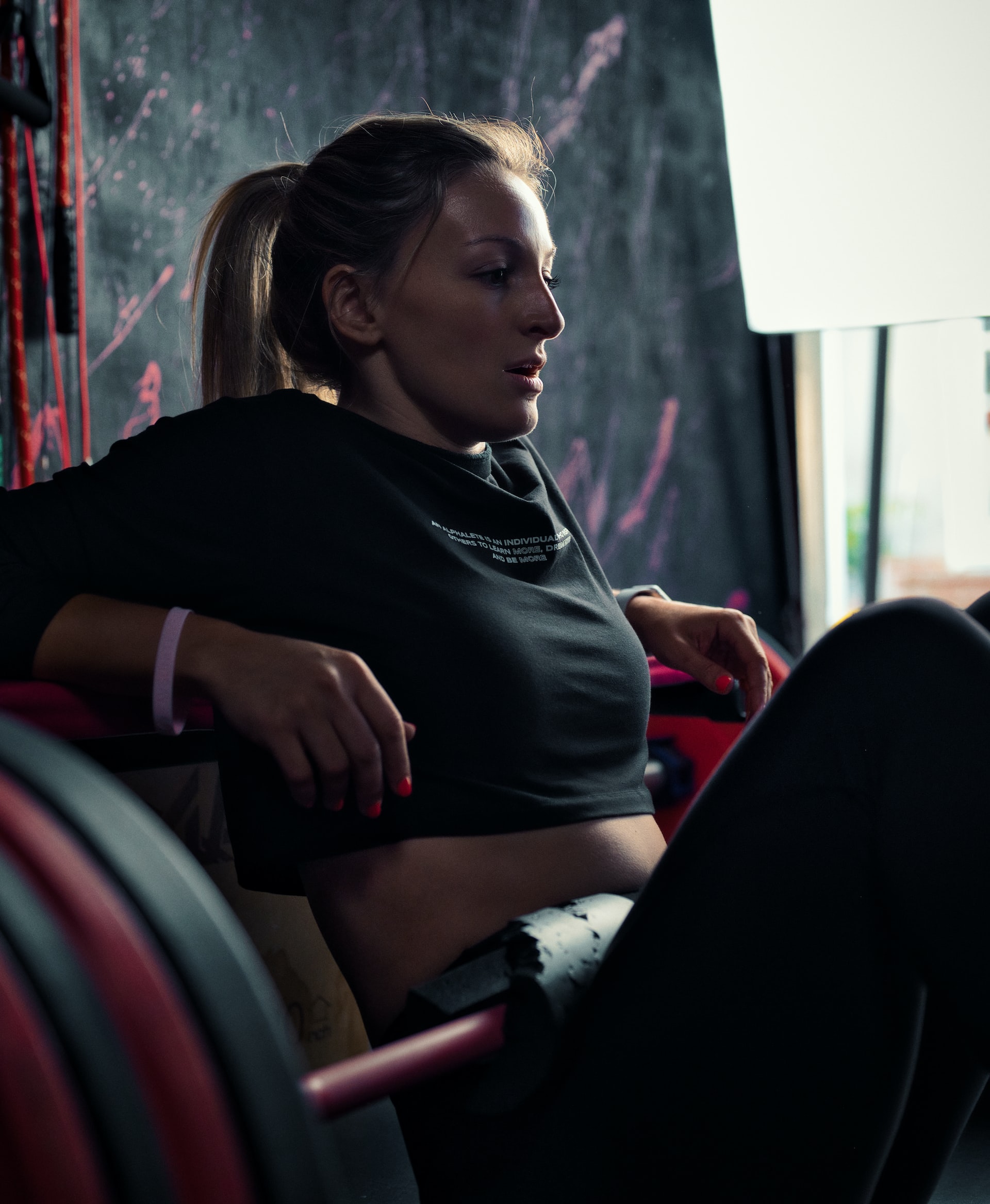 Women sitting on weight bar