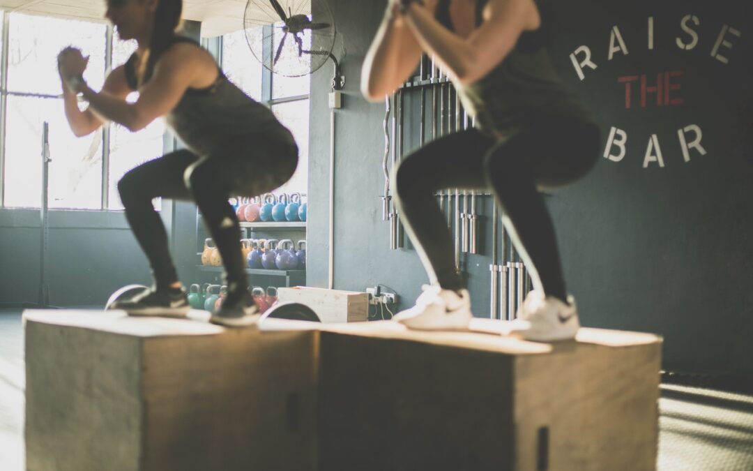 women squatting on box in empty room